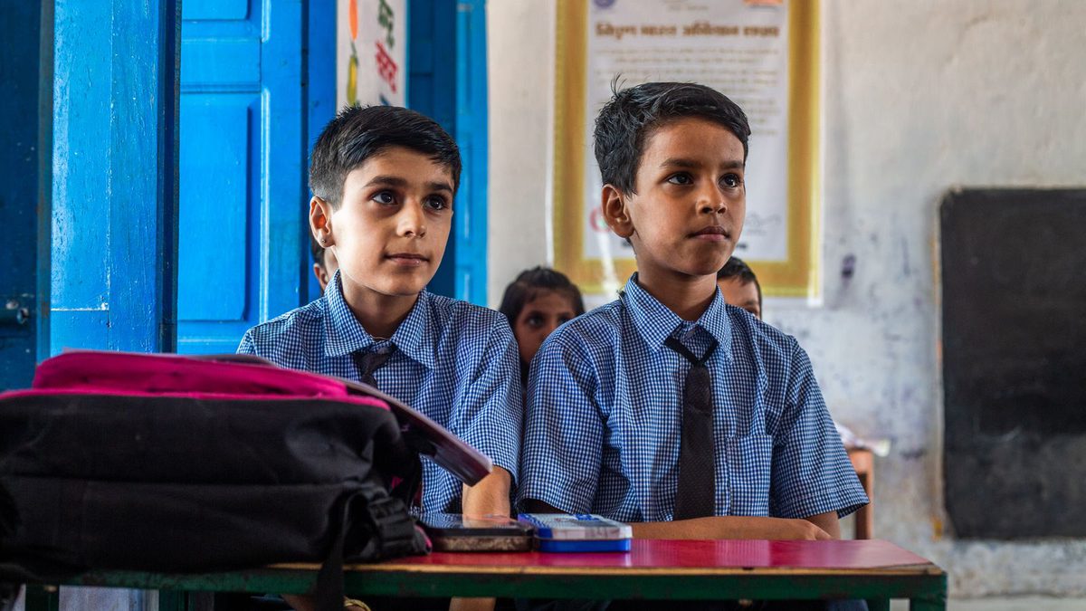Two schoolboys in uniform listening attentively in class